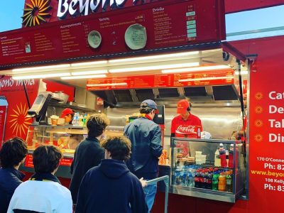 Beyond India food truck with customers and staff serving authentic Indian cuisine.
