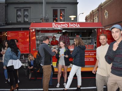 Beyond India food truck at Adelaide street fair, people enjoying Indian cuisine.